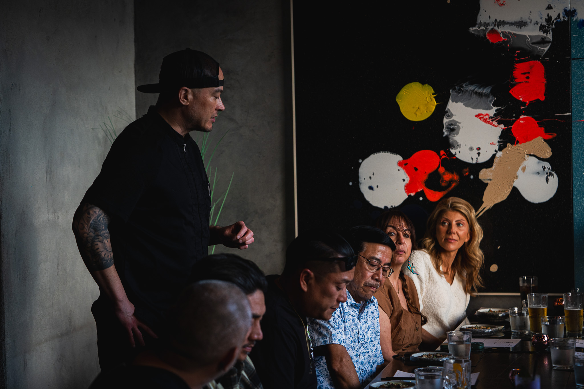 Cloak & Petal Chef's Table — the chef addressing guests at an intimate pop-up dinner in Little Italy, San Diego
