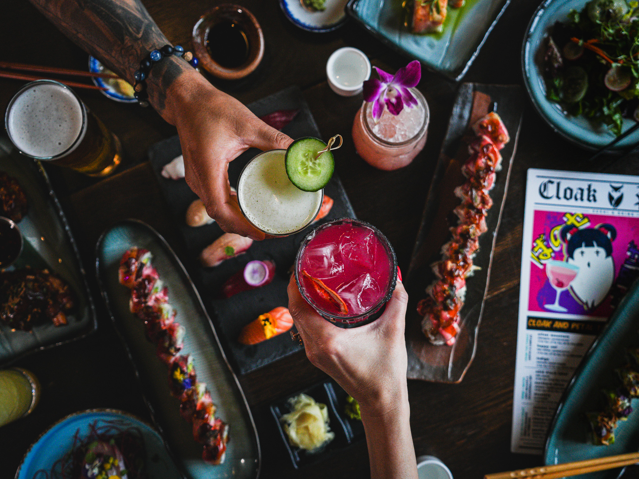 Cloak & Petal — sushi rolls, cocktails and small plates spread overhead view
