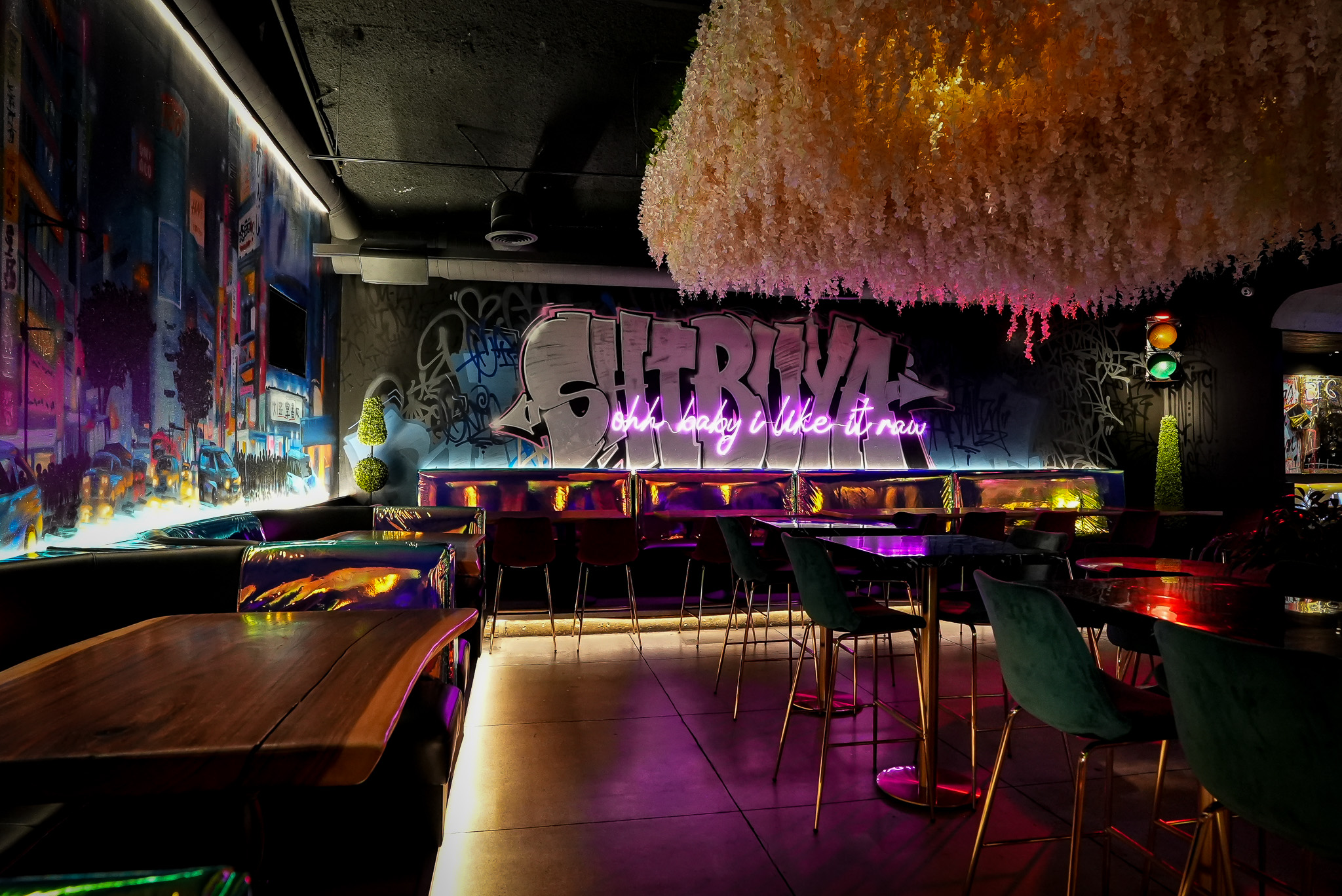 Inside Cloak & Petal — intimate dining room with warm lighting and Japanese-inspired decor in Little Italy