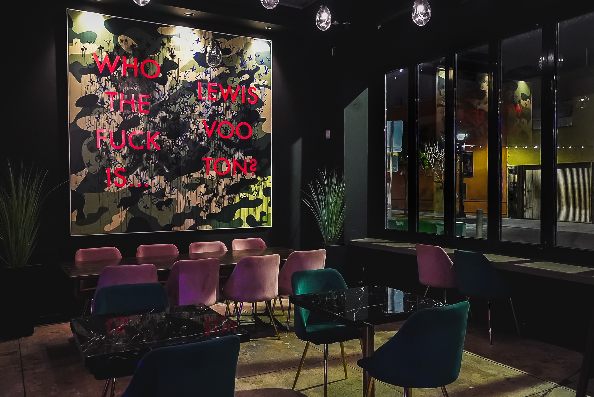 Cloak & Petal bar area with moody amber lighting